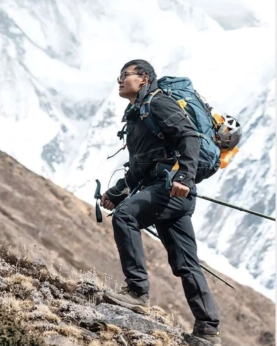 Tenzin, mountain guide, on the moraine below a glaciated peak