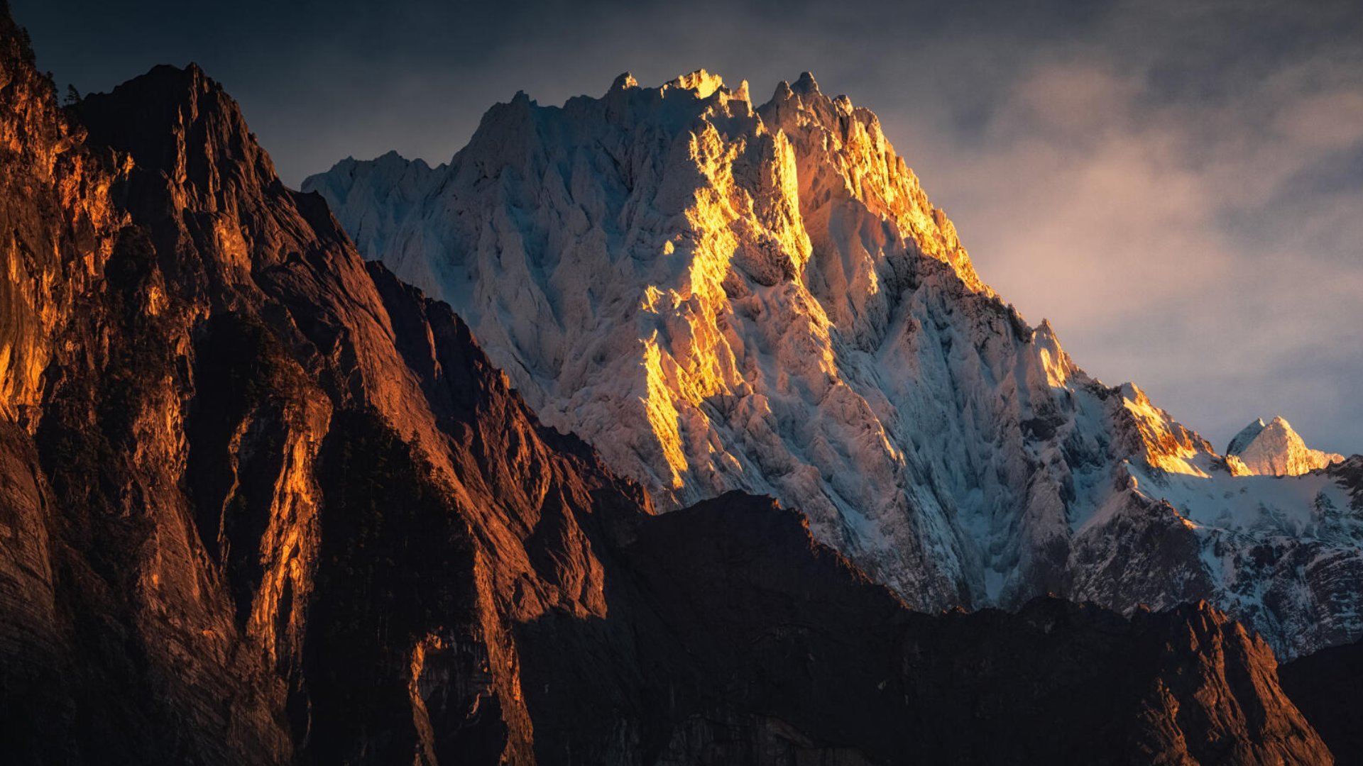 Sunrise on a 6,000 m snow wall above a Tibetan village